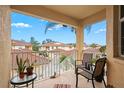 Balcony with chairs, plants, and view of neighboring buildings at 4206 Vicenza Dr # C24, Venice, FL 34293