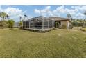Screened pool with spacious deck and surrounding landscaping at 4743 Butterfly Ln, North Port, FL 34288