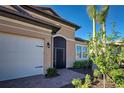 White garage door, screen door entry, and landscaping at 629 Maraviya Blvd, Nokomis, FL 34275