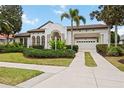 Spacious home with a large driveway and well manicured lawn at 6557 The Masters Ave, Lakewood Ranch, FL 34202