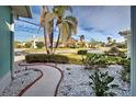 Landscaped walkway to the house with pebble stone ground covering at 660 Silk Oak Dr, Venice, FL 34293