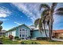 Single-story house with a two-car garage and landscaping at 660 Silk Oak Dr, Venice, FL 34293