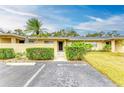 Front view of condo showing manicured lawn and parking at 7022 W Country Club N Dr, Sarasota, FL 34243