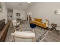 Open concept living room with hardwood floors and a comfortable seating area at 703 Ironwood Dr # 114, Venice, FL 34292