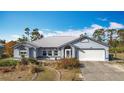 Well-maintained single-story home with an attached two-car garage and arched windows at 7321 Teaberry St, Englewood, FL 34224