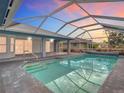 Enclosed backyard pool with a screened-in lanai, providing a private outdoor space at 7321 Teaberry St, Englewood, FL 34224