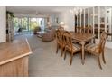 Open dining area with wood table and chairs, overlooking the living room at 801 Waterside Dr # 102, Venice, FL 34285