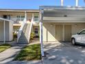 Condo building with covered parking and landscaping at 801 Waterside Dr # 102, Venice, FL 34285