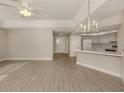 Bright living room with vinyl plank flooring, kitchen bar, and access to patio at 826 Bayport Cir, Venice, FL 34292