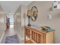 Bright condo entry with wood cabinet and mirror at 840 The Esplanade N # 703, Venice, FL 34285