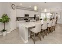 Modern kitchen with white cabinets, island, and stainless steel appliances at 10792 Tarflower Dr # 202, Venice, FL 34293