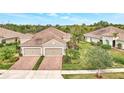 Luxury home with three-car garage and beautiful landscaping at 11409 Okaloosa Dr, Venice, FL 34293