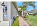 Brick walkway leading to the house entrance with landscaping at 11409 Okaloosa Dr, Venice, FL 34293