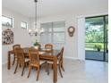 Dining room with wooden table, chairs, and access to the backyard at 11945 Lovegrass St, Venice, FL 34293