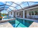 Relaxing pool and spa area with covered patio and outdoor seating at 12460 Davie Ct, Venice, FL 34293