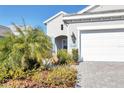 House exterior with landscaping and two car garage at 12488 Palatka Dr, Venice, FL 34293