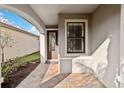Front entry with arched walkway and decorative door at 13864 Posada St, Venice, FL 34293