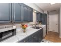 Renovated kitchen with dark cabinets, marble countertops, and stainless steel appliances at 140 Columbia Rd, Venice, FL 34293