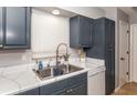 Kitchen with updated cabinets, marble countertops, and a double sink at 140 Columbia Rd, Venice, FL 34293