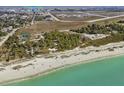 Aerial view of beachfront property near airport, showing beach access and park at 1423 Avenida Del Circo # 1C, Venice, FL 34285