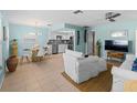 Bright living room with open floor plan, featuring a kitchen and dining area at 1423 Avenida Del Circo # 1C, Venice, FL 34285