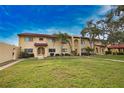 Condo building showcasing a well-maintained lawn and attractive architectural details at 1437 57Th W St # 1437, Bradenton, FL 34209
