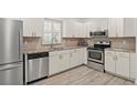 Modern kitchen featuring stainless steel appliances at 1531 Placida Rd # 1-103, Englewood, FL 34223