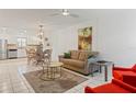 Bright living room with comfy seating and a large window at 1531 Placida Rd # 1-103, Englewood, FL 34223