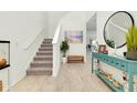 Bright foyer featuring wood floors, a staircase and stylish decorations at 1920 Sunset Preserve Way, Port Charlotte, FL 33953