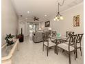 Bright dining area with glass-top table and chairs, adjacent to living room at 1931 San Silvestro Dr, Venice, FL 34285