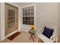 Small front porch with seating, a welcome mat and a vase of yellow roses at 1931 San Silvestro Dr, Venice, FL 34285