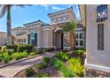 Mediterranean style home with stone accents and landscaped walkway at 20175 Elegante Ct, Venice, FL 34293