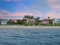Beachfront property showcasing a large house and surrounding landscape at 213 The Esplanade S, Venice, FL 34285