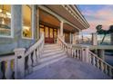 Elegant staircase leading to the home's entrance with ocean views at 213 The Esplanade S, Venice, FL 34285