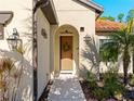 Inviting front door with wreath and walkway at 224 Ariano Ave, Nokomis, FL 34275