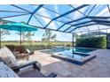 Relaxing pool area with lounge chairs and umbrella at 25064 Spartina Dr, Venice, FL 34293