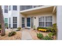 Condo building exterior with a nicely landscaped walkway at 400 Laurel Lake Dr # 105, Venice, FL 34292