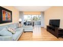 Living room with sectional sofa, sliding glass doors, and a flat-screen TV at 408 Cerromar S Cir # 132, Venice, FL 34293