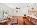 Bright living room with hardwood floors, a leather couch, and large windows at 4310 Albacore Cir, Port Charlotte, FL 33948