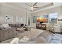 Spacious living room with large TV, comfortable seating and hardwood floors at 438 Grand Preserve Cv, Bradenton, FL 34212