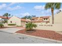 Attractive two-story building with terracotta tile roofs and neatly landscaped grounds at 440 Palmetto Ct # 3, Venice, FL 34285