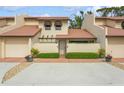 Two story condo with Spanish tile roof, attached garage, and landscaped front at 440 Palmetto Ct # 3, Venice, FL 34285