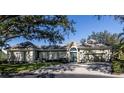 House with a gray facade, shutters, and a paved driveway at 441 Tremingham Way, Venice, FL 34293