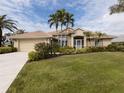 Single-story home with tile roof, screened porch and manicured lawn at 5045 Whitestone Dr, Venice, FL 34293