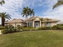 One-story home with tile roof, screened porch, and lush landscaping at 5045 Whitestone Dr, Venice, FL 34293