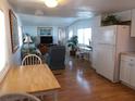 Open kitchen with white cabinets, light wood floors, and view of living room at 516 Ashwood Dr, Venice, FL 34285