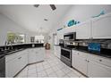 Modern kitchen with white cabinets, granite countertops, and stainless steel appliances at 538 Laurel Cherry Ln, Venice, FL 34293