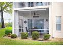 Screened lanai with patio furniture and ceiling fan at 5800 Sabal Trace Dr # 701, North Port, FL 34287