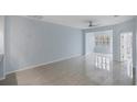 Light blue living room with tile floors and ceiling fan at 640 Back Nine Dr, Venice, FL 34285