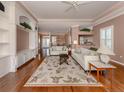 Bright living room with hardwood floors, built-in shelving, and neutral decor at 651 Lakescene Dr, Venice, FL 34293